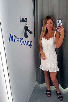 In the fitting room in a dress with no panties on.'